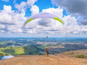 Hiker enjoying a panoramic view of snow-capped mountains during an adventure trek in Uttarakhand